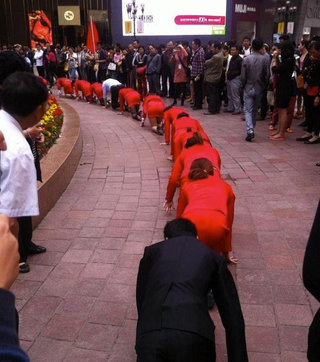 Illustration for article titled Chinese Employees Made To Crawl in Public